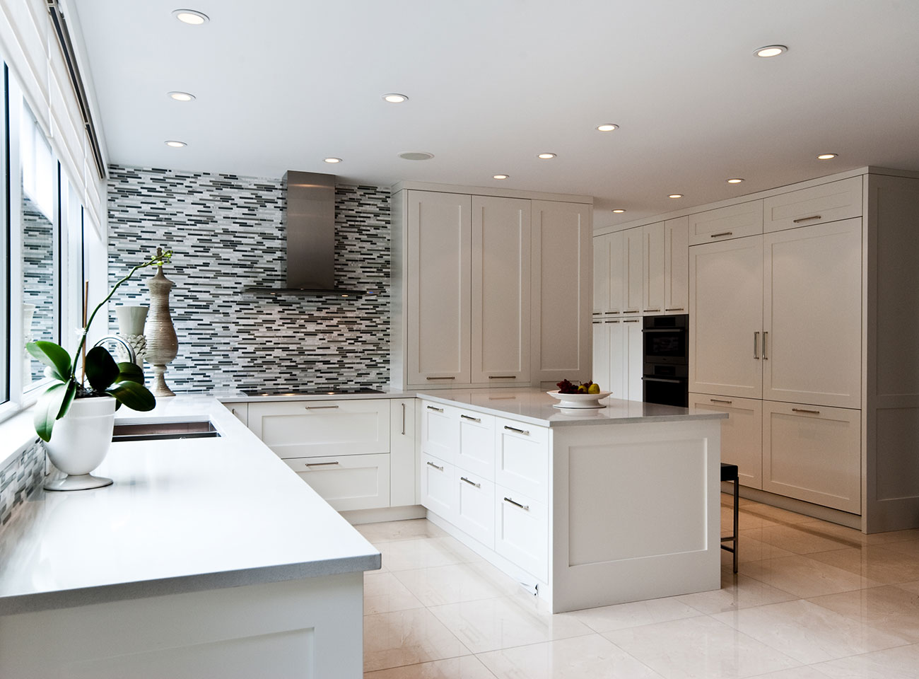 Detail of hand-finished white cabinetry doors and drawers in a custom kitchen